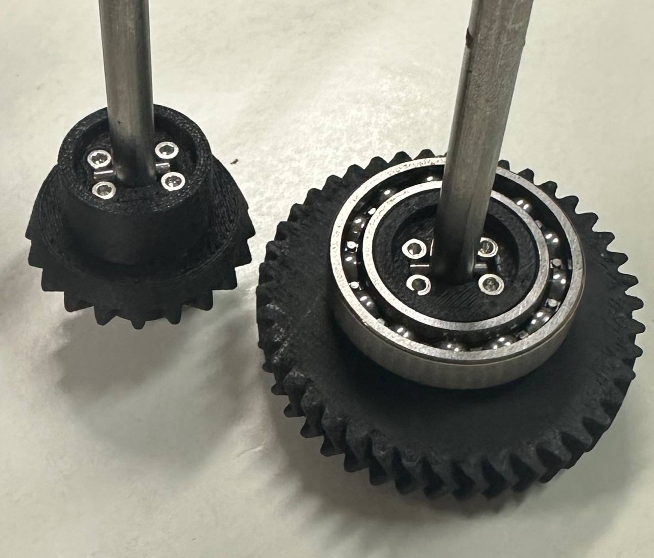 D-shaft and pin interface with the bevel gear and helical gear stack.